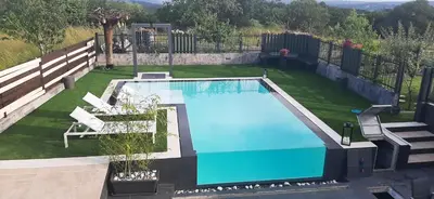 a swimming pool in a yard with chairs at CASA VACACIONAL ACIO in Ourense
