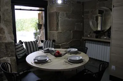 a table with bowls and plates on top of it at CASA VACACIONAL ACIO in Ourense