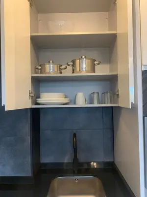 a kitchen with a sink and pots and pans on a shelf at lucushouse III in Lugo