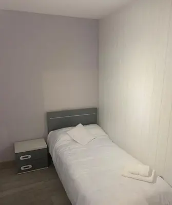 a small bedroom with a bed and a night stand at lucushouse III in Lugo