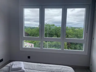 a bedroom with a large window with a bed in it at lucushouse III in Lugo