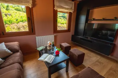 a bathroom with a sink and a toilet and a window at Casa Visita Ribeira Sacra in Chantada