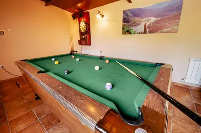 a pool table with balls on it in a room at Casa Visita Ribeira Sacra in Chantada