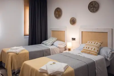 two beds in a hotel room with towels on them at Beche EcoCamp in Santa Eulalia