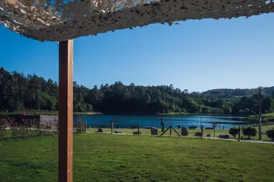 a view of a lake from a playground at Beche EcoCamp in Santa Eulalia