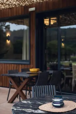 a table and chairs on a patio with a table and chairs at Beche EcoCamp in Santa Eulalia
