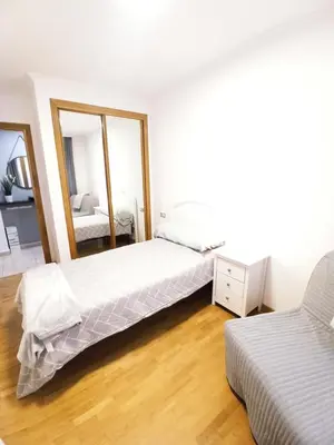 a bedroom with two beds and a mirror at Viveiro Muralla in Viveiro