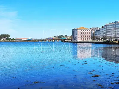 a large body of water with buildings in the background at Viveiro Muralla in Viveiro
