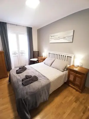 a bedroom with a bed with two towels on it at Viveiro Muralla in Viveiro
