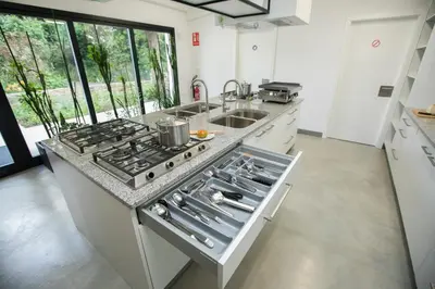 a kitchen with a stove top oven next to a sink at ALBERGUE O FERVELLO in Santiago de Compostela