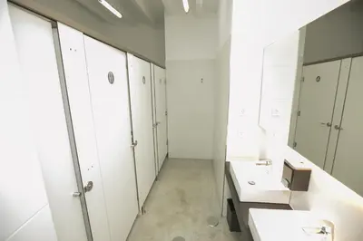 a bathroom with two sinks and white cabinets at ALBERGUE O FERVELLO in Santiago de Compostela