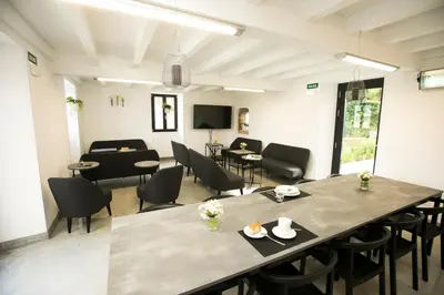 a dining room with a large table and chairs at ALBERGUE O FERVELLO in Santiago de Compostela