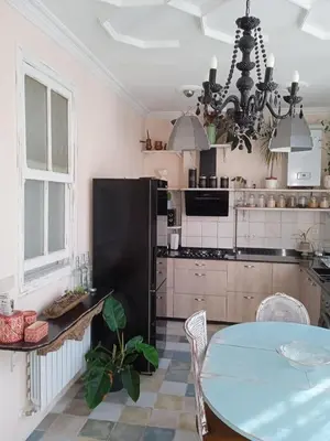 a kitchen with a table and a black refrigerator at Piso Iwvaxi, gallery house. Ourense. in Ourense