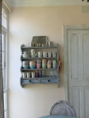 a shelf with plates and bowls on a wall at Piso Iwvaxi, gallery house. Ourense. in Ourense