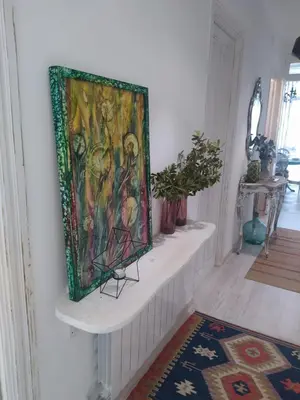 a painting is hanging on a wall in a room at Piso Iwvaxi, gallery house. Ourense. in Ourense