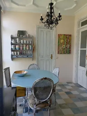 a dining room with a blue table and chairs at Piso Iwvaxi, gallery house. Ourense. in Ourense