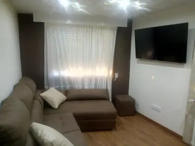 a living room with a couch and a flat screen tv at Casa o Cantón in Berredo