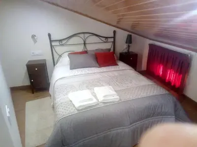 a bedroom with a bed with two towels on it at Casa o Cantón in Berredo