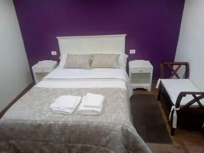 a bedroom with a large bed with two towels on it at Casa o Cantón in Berredo