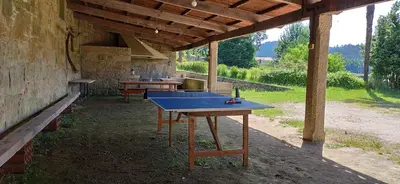 a ping pong table sitting inside of a building at Finca Bouzas in Teo