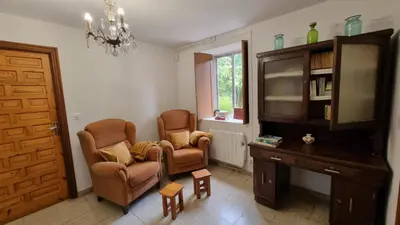 a living room with two chairs and a desk at Finca Bouzas in Teo