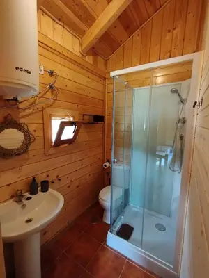 a bathroom with a shower and a sink at CAMPING LA ZARAPICA - Palacios del Sil in Palacios del Sil
