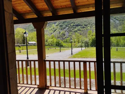 a view of a park from a porch at CAMPING LA ZARAPICA - Palacios del Sil in Palacios del Sil