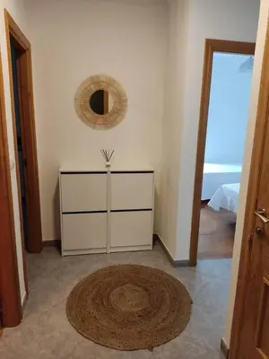 a room with a dresser and a mirror on the wall at APARTAMENTOS SARMIENTO in Mondoñedo