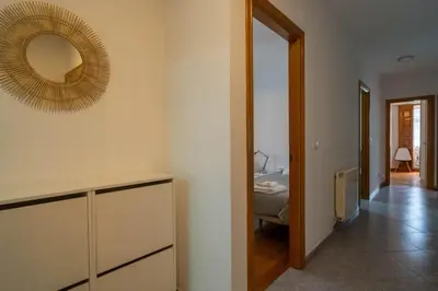 a room with a mirror on the wall and a bed at APARTAMENTOS SARMIENTO in Mondoñedo