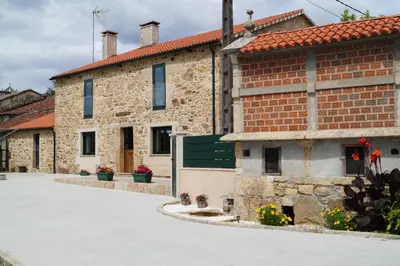 a brick building with a green bench in front of it at Casa Marisa in Teo