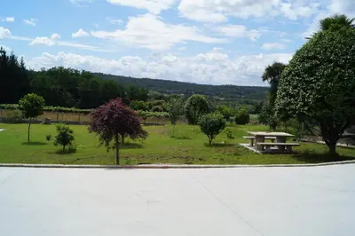 a park with a bench and a picnic table at Casa Marisa in Teo