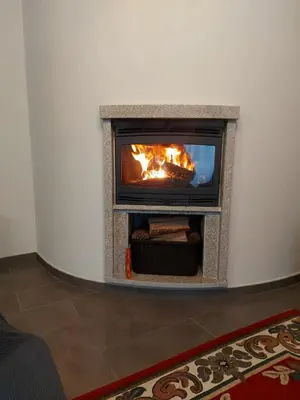 a fireplace in a living room with a fire in it at Casa Marisa in Teo