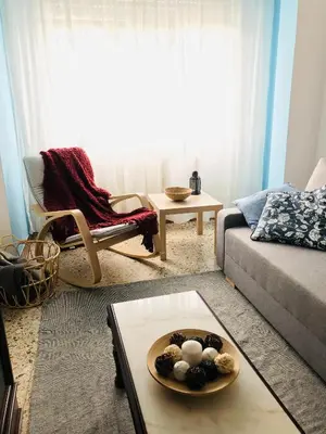 a living room with a couch and a plate of eggs on a table at Casa CHORIMA in Arzúa