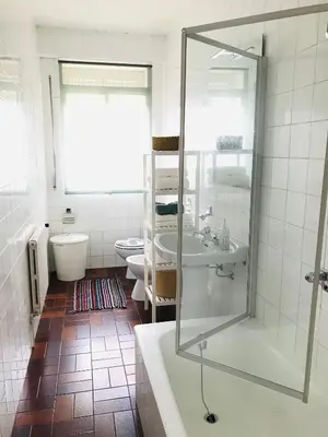 a bathroom with a shower and a sink and a tub at Casa CHORIMA in Arzúa