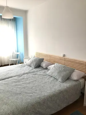 a bedroom with a bed with pillows on it at Casa CHORIMA in Arzúa