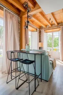 a dining room with a blue table and chairs at Apartamentos Turísticos Casa Arango in Ribadeo