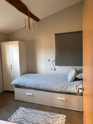 a bedroom with a bed with a large headboard at Casa Rural Elvira Ribeira Sacra in Asma