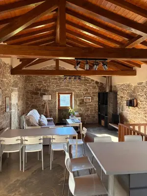 a living room with a table and some chairs at Casa Rural Elvira Ribeira Sacra in Asma