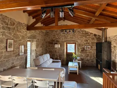 a living room with a couch and a table at Casa Rural Elvira Ribeira Sacra in Asma