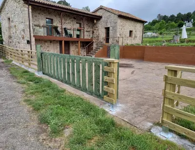 a wooden fence in front of a house at Casa Rural Elvira Ribeira Sacra in Asma