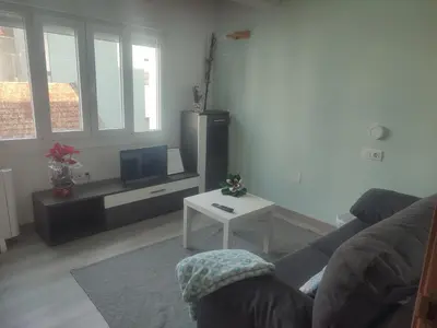a living room with a couch and a tv and a table at Apartamento TerradeAugas3 in Caldas de Reis