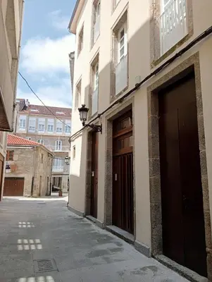 an empty alley with two entrances to a building at Apartamentos Tras dos Fornos in Chantada