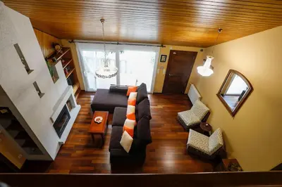 a view of a living room with a couch and chairs at Villa Albino Piscina climatizada in Ribas del Sil