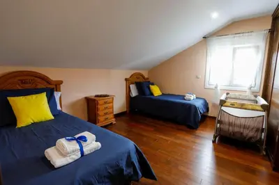 a bedroom with two beds with towels on them at Villa Albino Piscina climatizada in Ribas del Sil