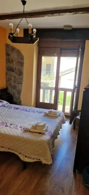 a bedroom with two beds with towels on them at Casa Rustica CESAR in Lubián