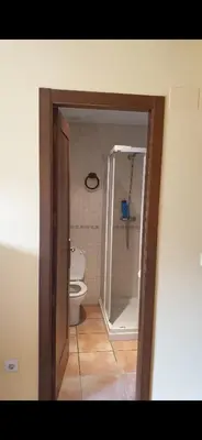 a bathroom with a toilet and a shower and a tub at Casa Rustica CESAR in Lubián
