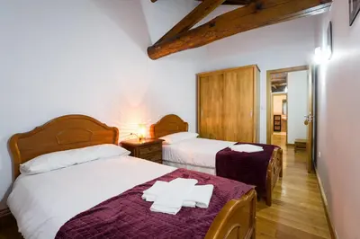 a bedroom with two beds with towels on the bed at Casa D'Abaixo in Arzúa