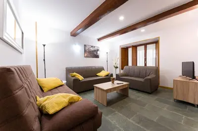 a living room with two couches and a tv at Casa D'Abaixo in Arzúa