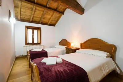 a bedroom with two beds with towels on them at Casa D'Abaixo in Arzúa