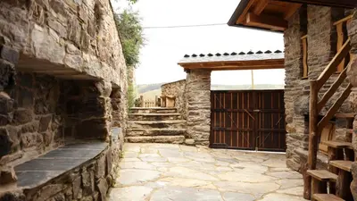 an entrance to a stone building with a wooden gate at Casa do Bico in Becerreá